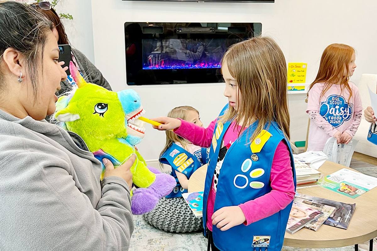 Kids learning brushing at a Kids Club event