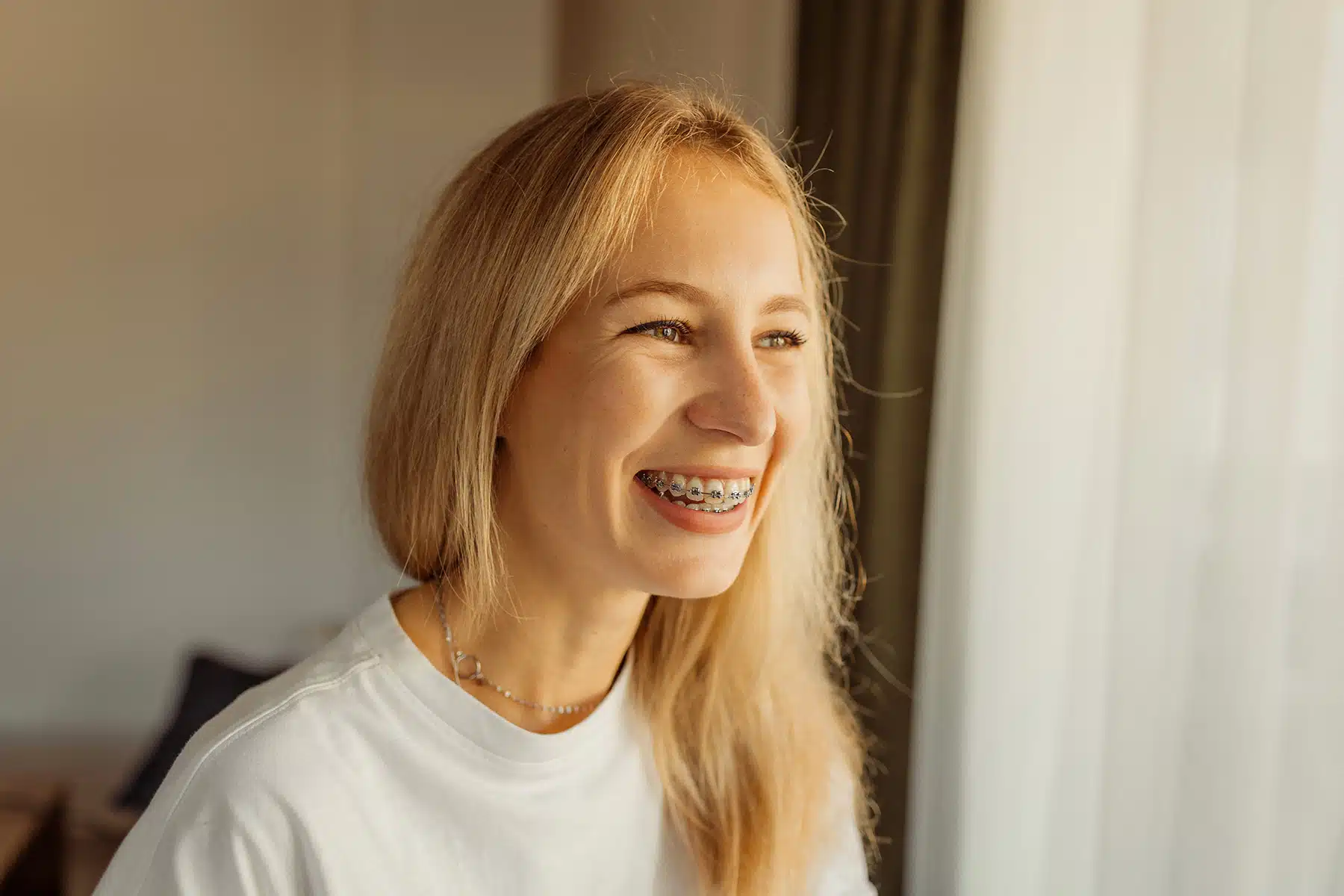 An adult smiling with braces