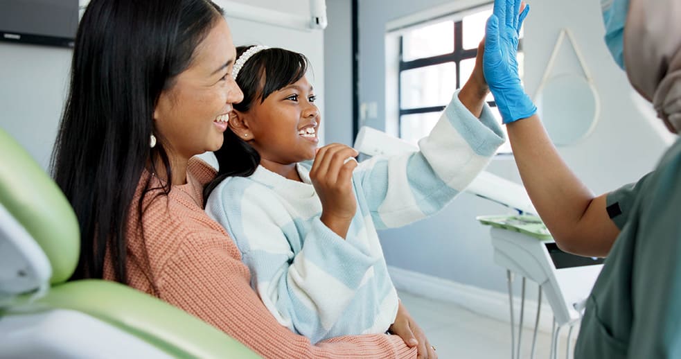 young girl with her mother during pediatric dentist appointment with the Dental Kids Club at Refined Orthodontics