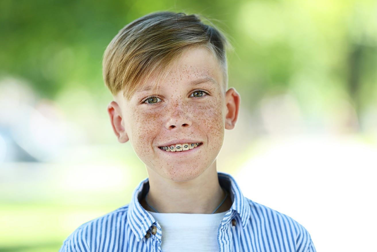 young boy smiling in midland texas showing braces from refined orthodontics